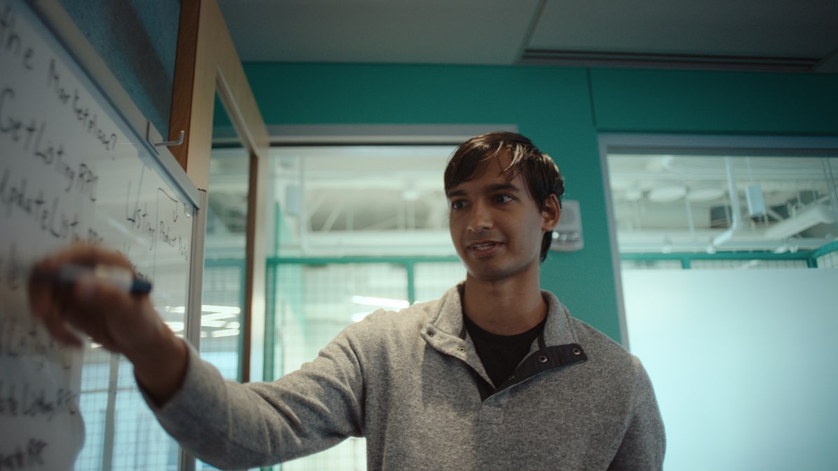 HubSpot engineer at whiteboard - company reports 40% productivity boost after deploying Claude AI across engineering, marketing, and customer success teams
